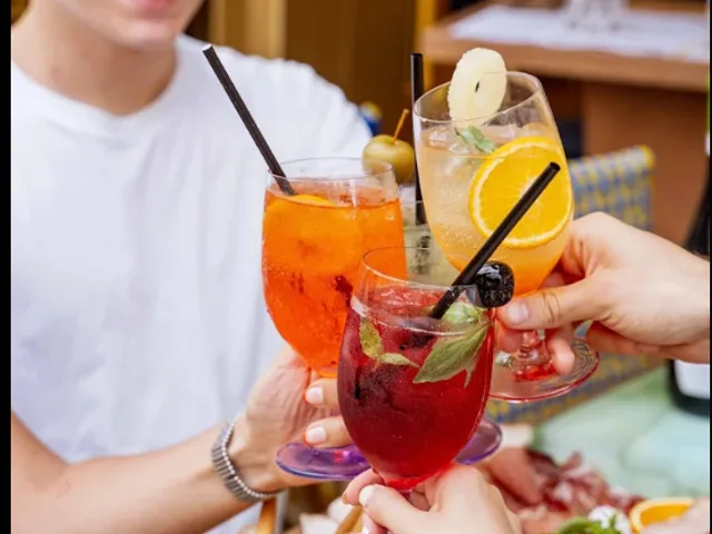 A table of Spritz drinks shared with friends during aperitivo in Paris